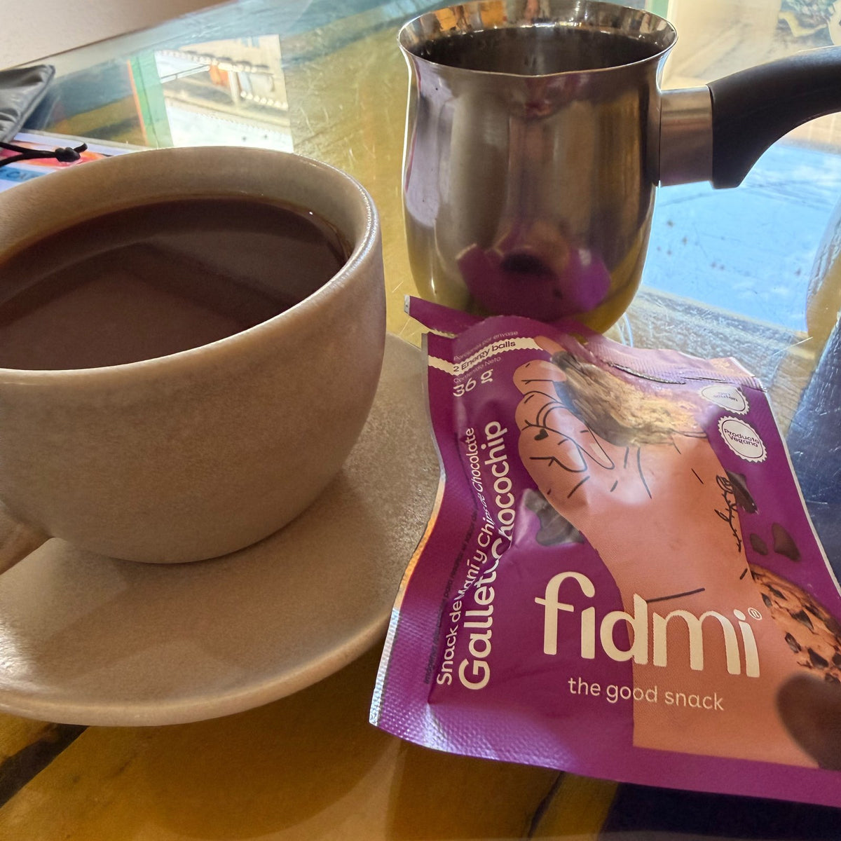 A Fidmi pack next to a morning coffee